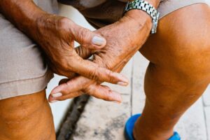 Close-up of elderly hands clasped in a relaxed position outdoors in Cebu City, Philippines.