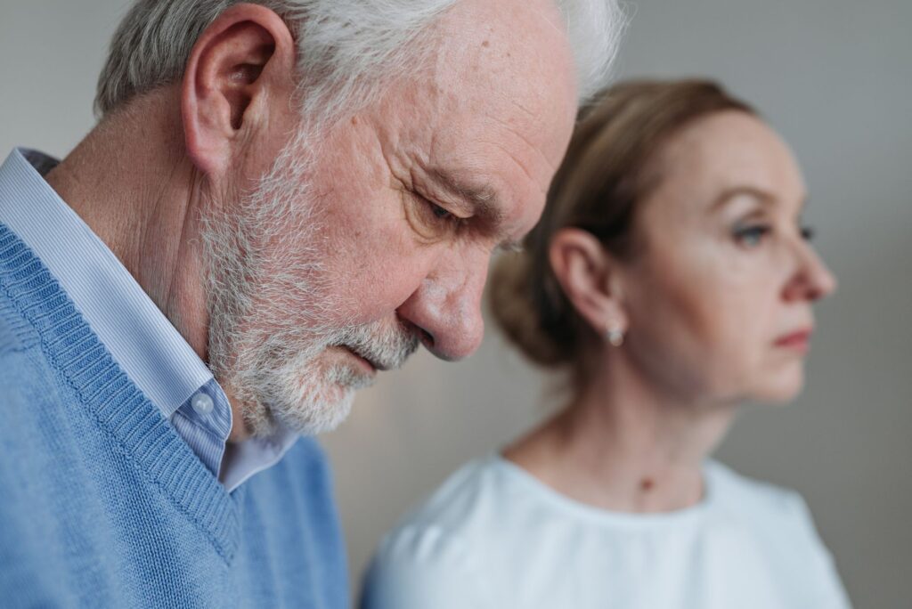 Close-up portrait of an elderly couple experiencing deep emotions and reflection.