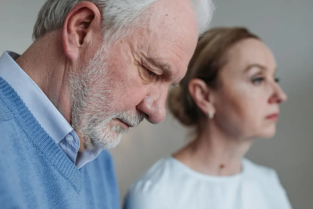 Close-up portrait of an elderly couple experiencing deep emotions and reflection.