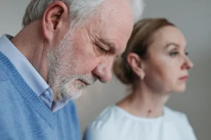 Close-up portrait of an elderly couple experiencing deep emotions and reflection.